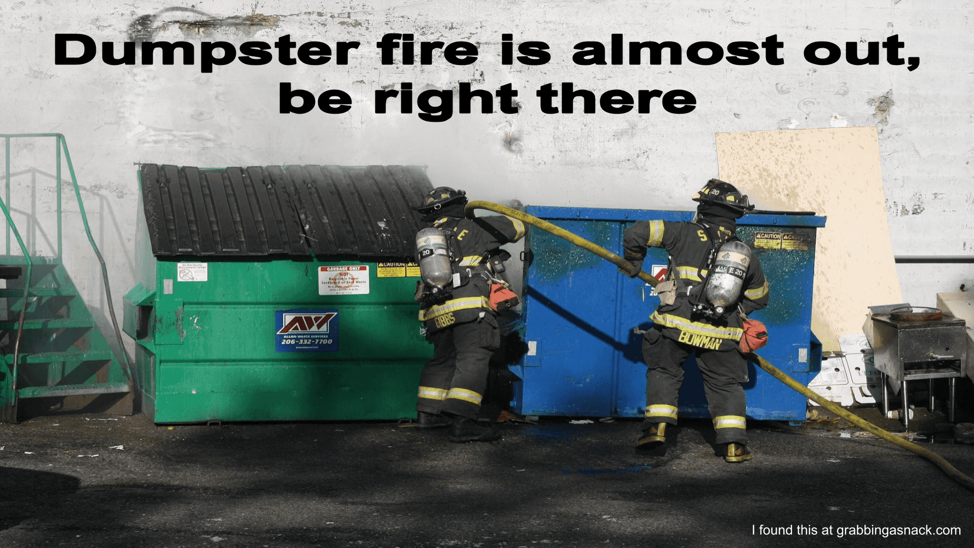 Firefighters putting out a dumpster fire with the words, 'dumpster fire is almost out, be right there'